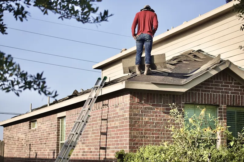 Professional roofer working on a residential roof in Fort Hill - Roosevelt